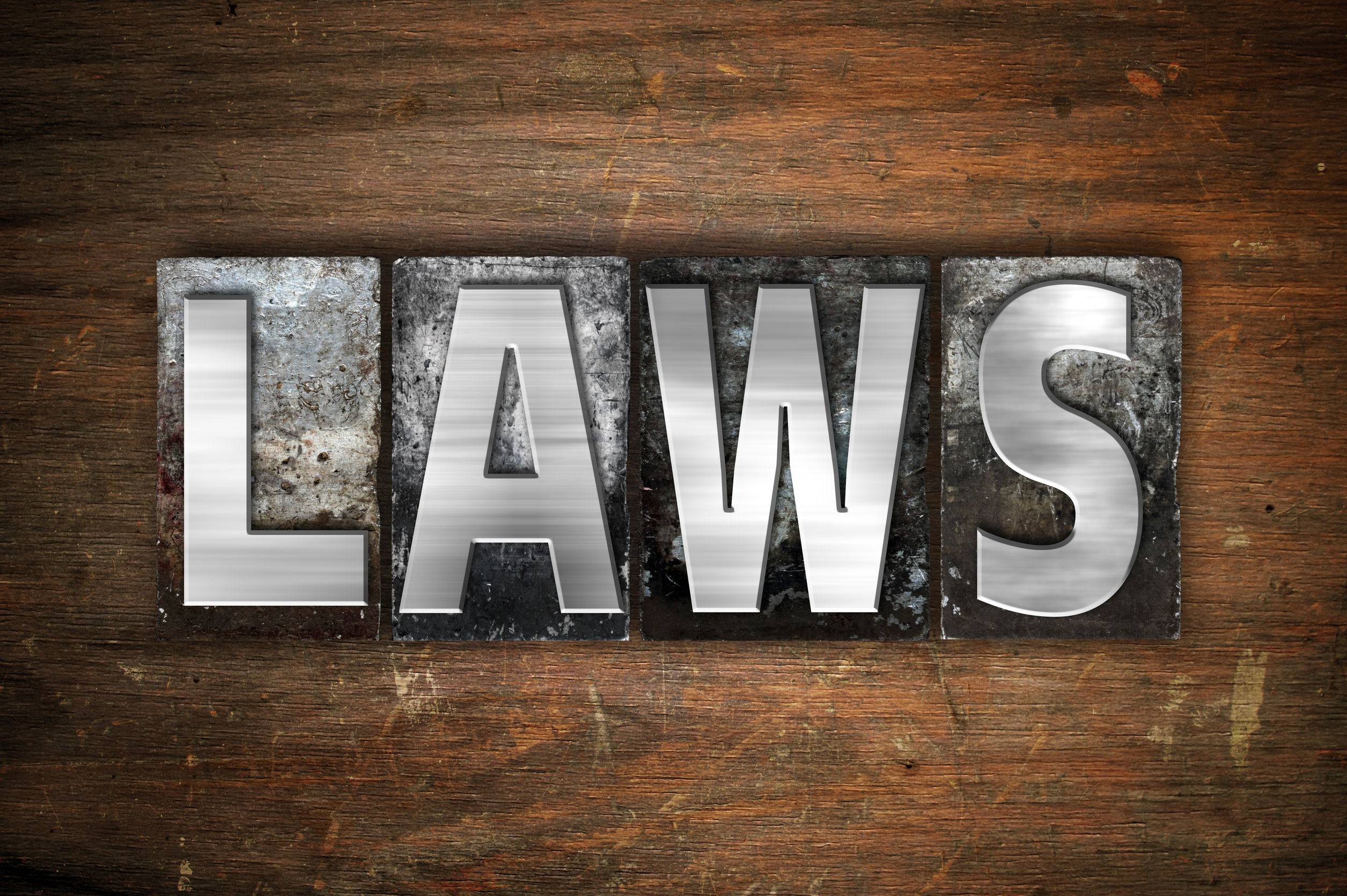 51395983 - the word "laws" written in vintage metal letterpress type on an aged wooden background.